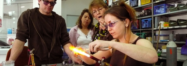 Turning glass beads in a team