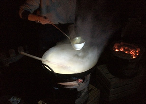 Cooking over the fire at a traditional oven house