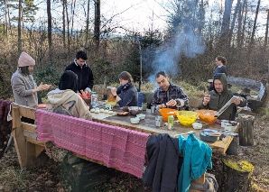 Team cooking over an open fire