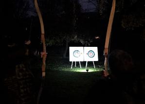 bow and arrow by night with fire